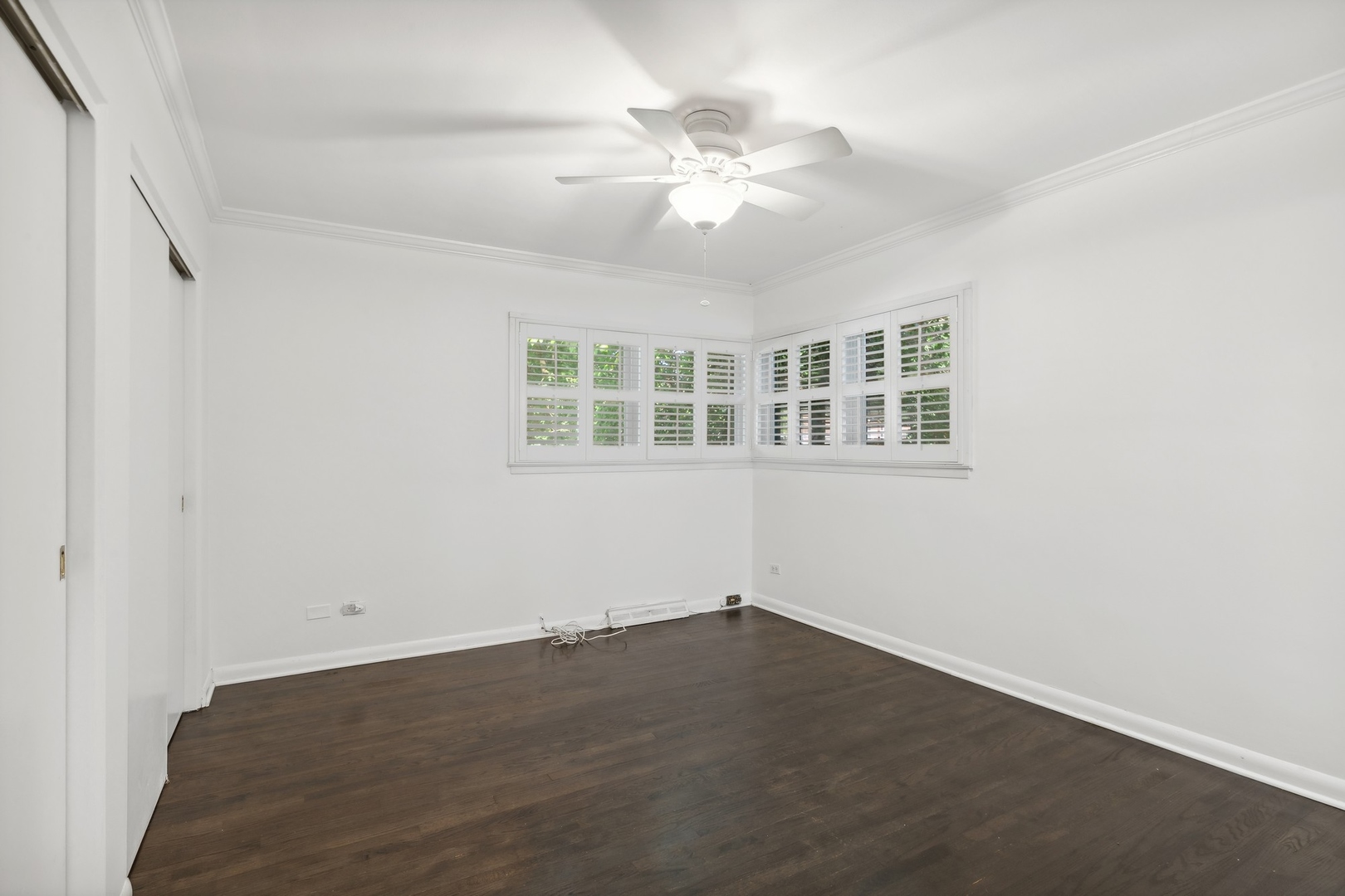 517 Romona Road Wilmette, IL 60091 - Photo 7 of 21 an empty room with wooden floor and windows
