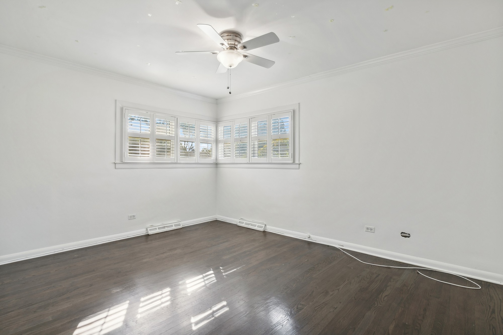 517 Romona Road Wilmette, IL 60091 - Photo 9 of 21 an empty room with wooden floor and windows