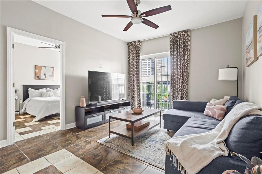 195 14th Street Northeast, Unit 604 Atlanta, GA 30309 - Photo 1 of 25 a living room with furniture and a flat screen tv