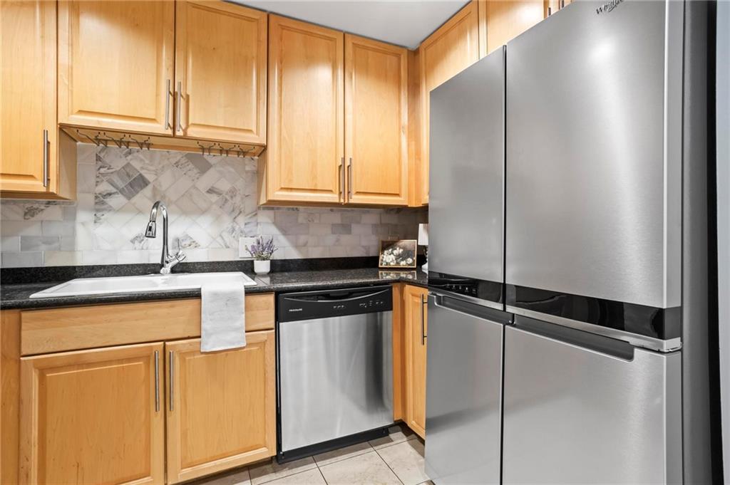 195 14th Street Northeast, Unit 604 Atlanta, GA 30309 - Photo 13 of 25 a kitchen with a refrigerator and cabinets