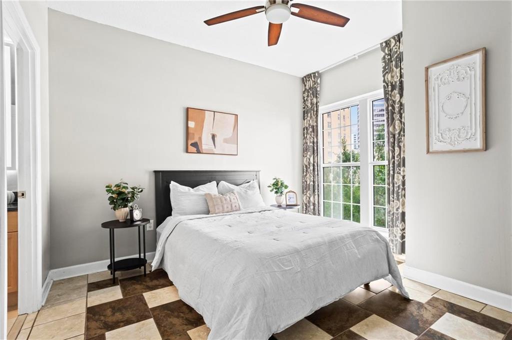 195 14th Street Northeast, Unit 604 Atlanta, GA 30309 - Photo 14 of 25 a bedroom with a bed and a window