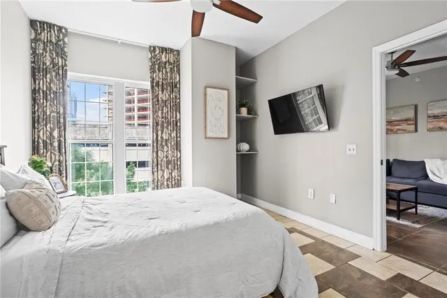 a bedroom with a large bed and a flat tv screen