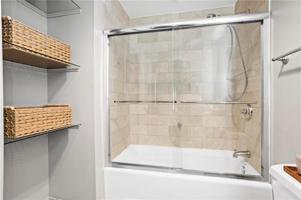 195 14th Street Northeast, Unit 604 Atlanta, GA 30309 - Photo 18 of 25 a bathroom with a bath tub and a shower