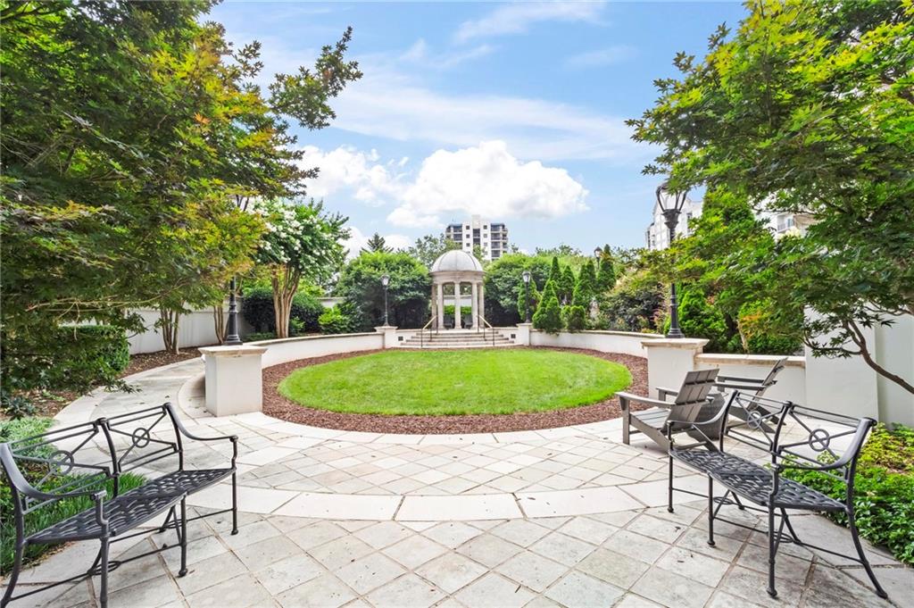 195 14th Street Northeast, Unit 604 Atlanta, GA 30309 - Photo 25 of 25 a blue swimming pool with a yard and trees