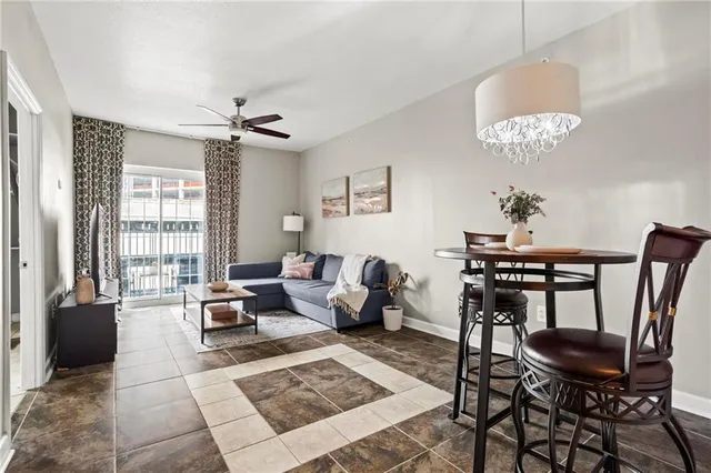 a living room with furniture two lamps and a chandelier