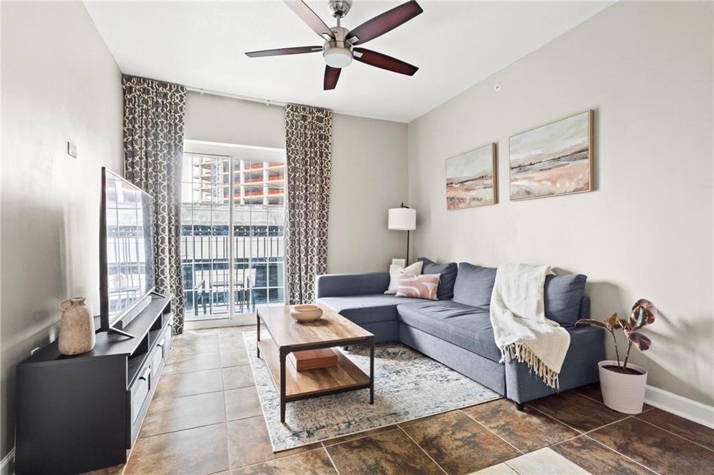 195 14th Street Northeast, Unit 604 Atlanta, GA 30309 - Photo 5 of 25 a living room with furniture and a large window