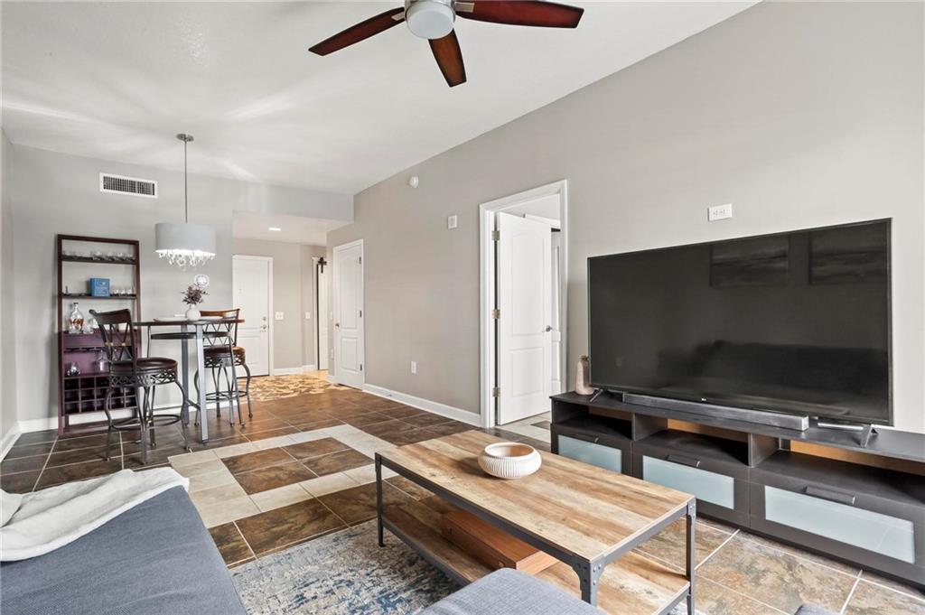 195 14th Street Northeast, Unit 604 Atlanta, GA 30309 - Photo 6 of 25 a living room with furniture and a flat screen tv