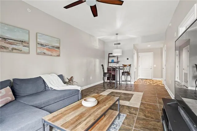 a living room with furniture and kitchen view