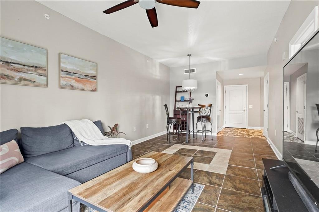 195 14th Street Northeast, Unit 604 Atlanta, GA 30309 - Photo 7 of 25 a living room with furniture and kitchen view