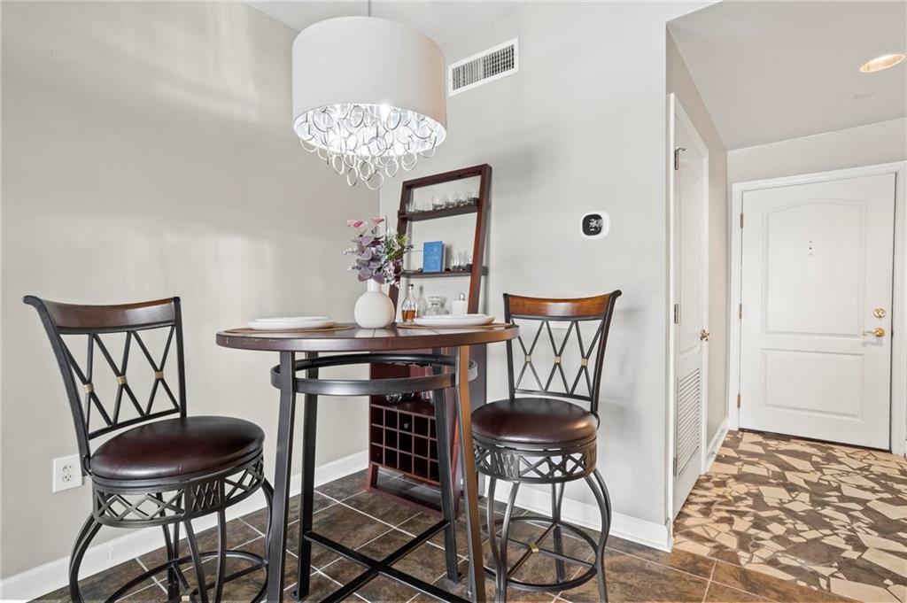 195 14th Street Northeast, Unit 604 Atlanta, GA 30309 - Photo 9 of 25 a view of a dining room with furniture and chandelier