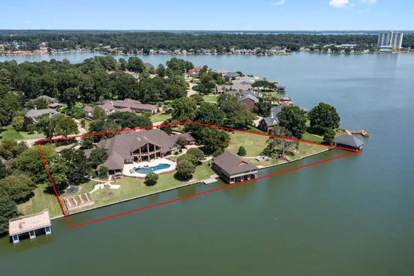an aerial view of a house with a lake view