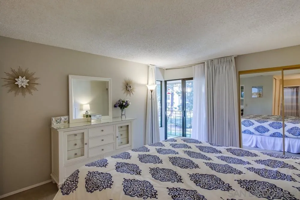 17617 Pomerado Road, Unit 215 San Diego, CA 92128 - Photo 11 of 50 a bedroom with a bed and a dresser in it