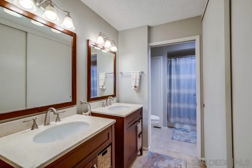 17617 Pomerado Road, Unit 215 San Diego, CA 92128 - Photo 14 of 50 a bathroom with a sink double vanity and a mirror
