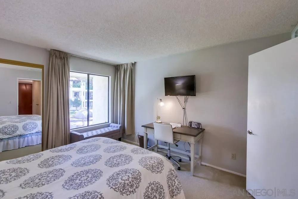 17617 Pomerado Road, Unit 215 San Diego, CA 92128 - Photo 18 of 50 a bedroom with a bed and a flat screen tv