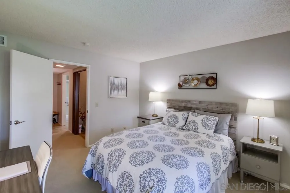 17617 Pomerado Road, Unit 215 San Diego, CA 92128 - Photo 19 of 50 a bedroom with a bed and a lamp