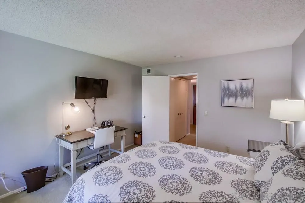 17617 Pomerado Road, Unit 215 San Diego, CA 92128 - Photo 20 of 50 a bedroom with a bed and a flat screen tv