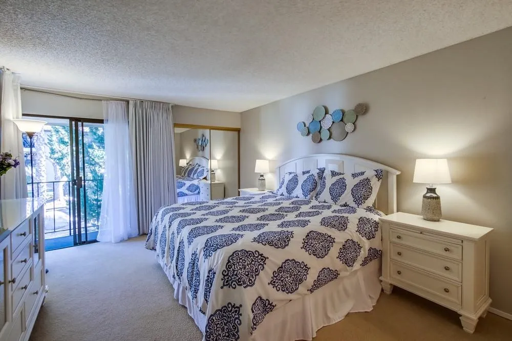 17617 Pomerado Road, Unit 215 San Diego, CA 92128 - Photo 10 of 50 a bedroom with a large bed and a chandelier
