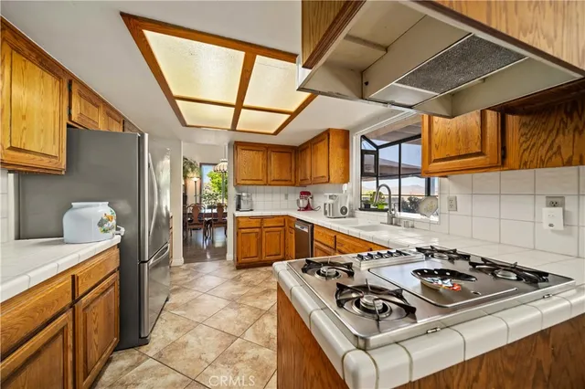 a kitchen that has a sink and a stove