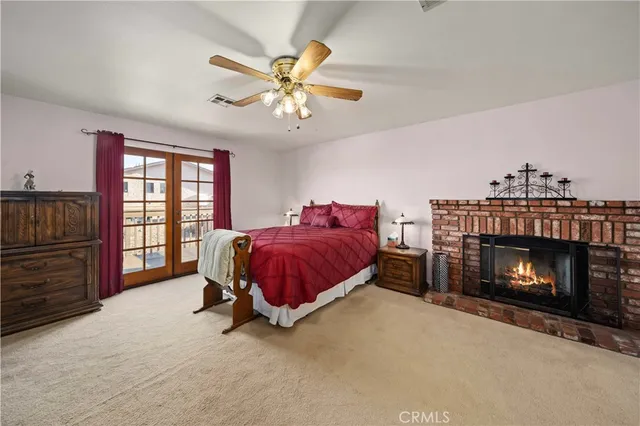 a spacious bedroom with a bed and a fireplace