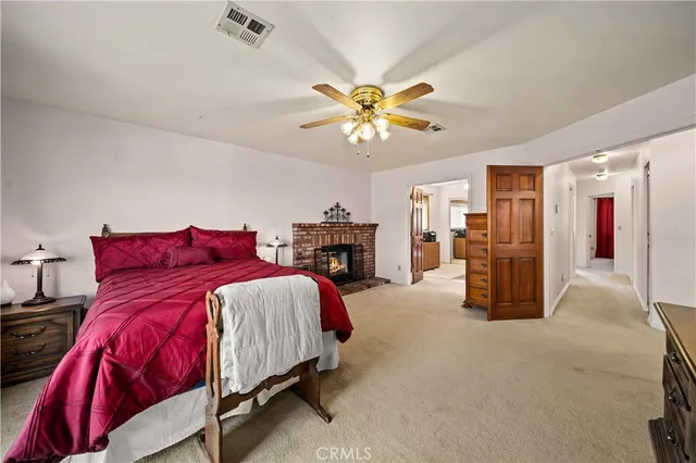 a spacious bedroom with a bed and a chandelier