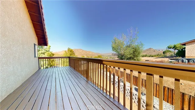 a view of balcony with wooden floor