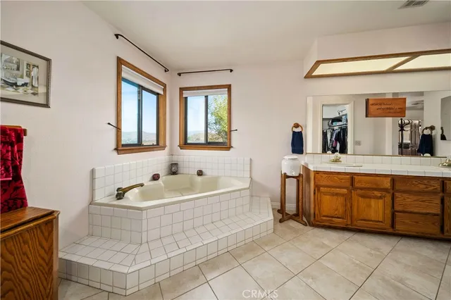 a spacious bathroom with a sink mirror and bathtub