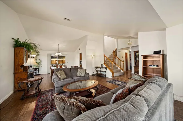a living room with furniture a rug and a floor to ceiling window