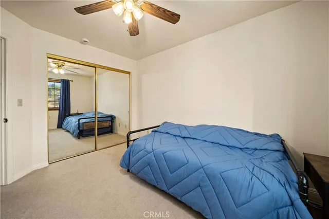 a bedroom with a bed and lamp