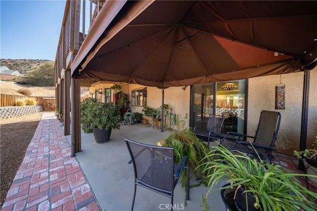a view of an outdoor sitting area with furniture and backyard