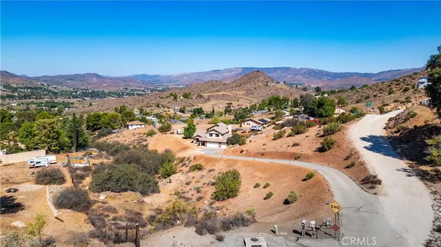 a view of a field with a mountain in the background