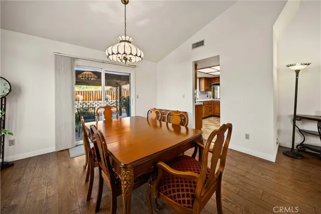 a view of a dining room with furniture wooden floor and chandelier