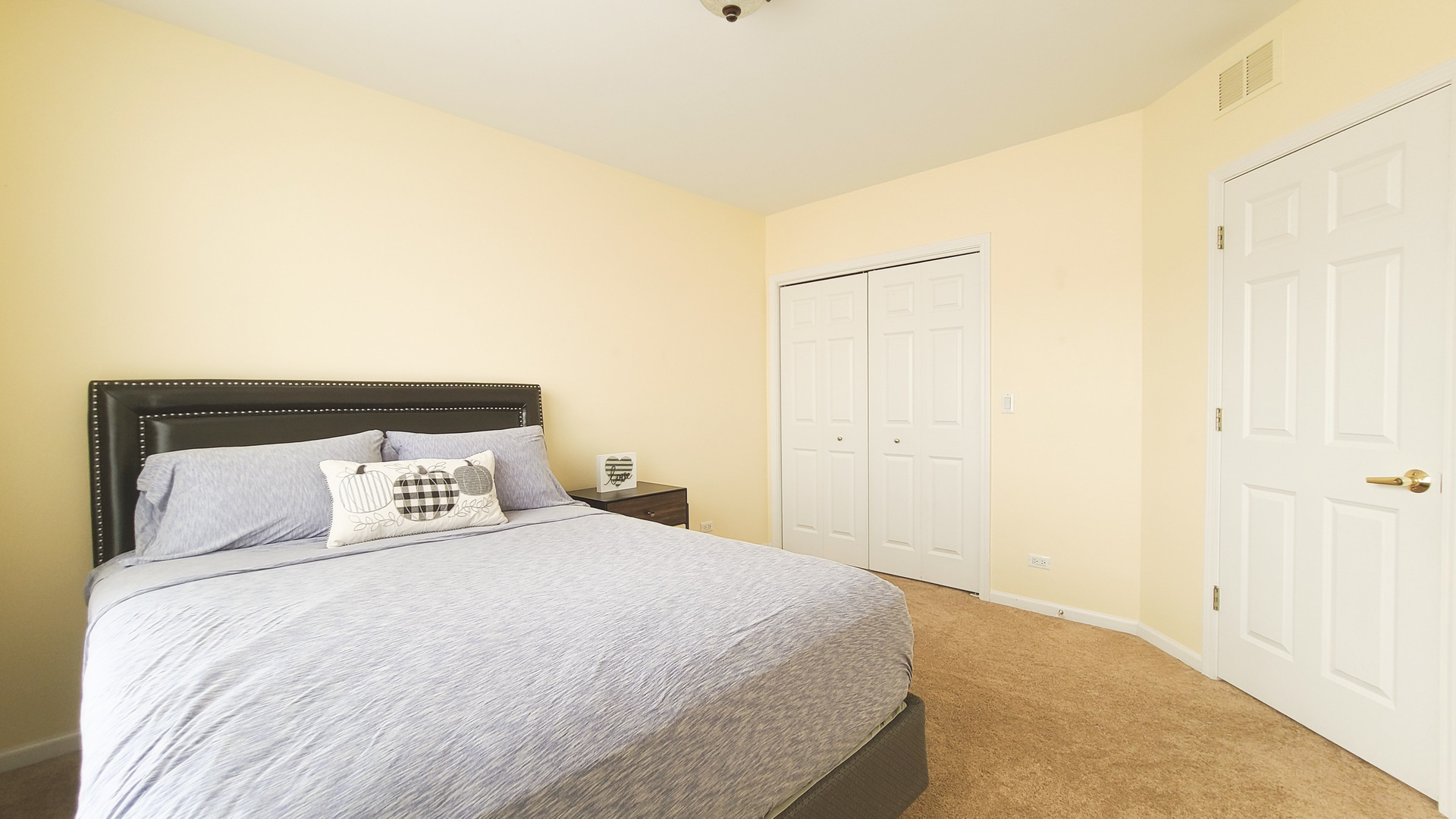 352 West Seminary Avenue, Unit 504 Wheaton, IL 60187 - Photo 21 of 24 a bedroom with a bed and a night stand