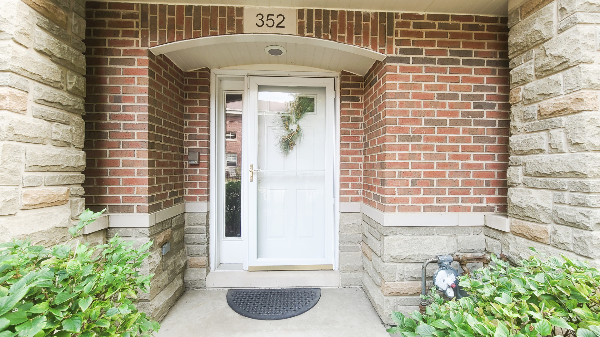 352 West Seminary Avenue, Unit 504 Wheaton, IL 60187 - Photo 3 of 24 a front view of a house with a yard