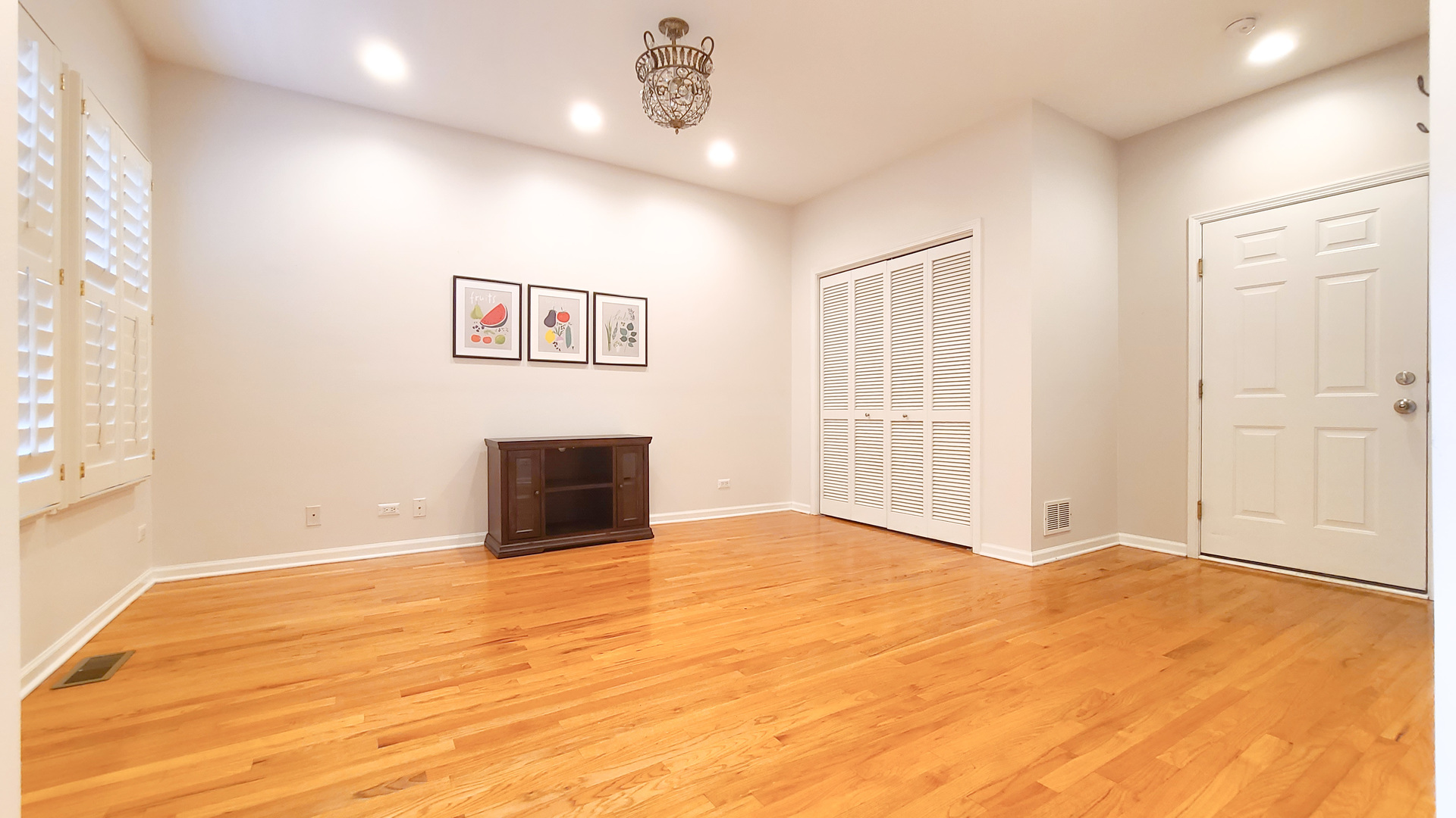 352 West Seminary Avenue, Unit 504 Wheaton, IL 60187 - Photo 4 of 24 a view of an empty room with wooden floor and a window