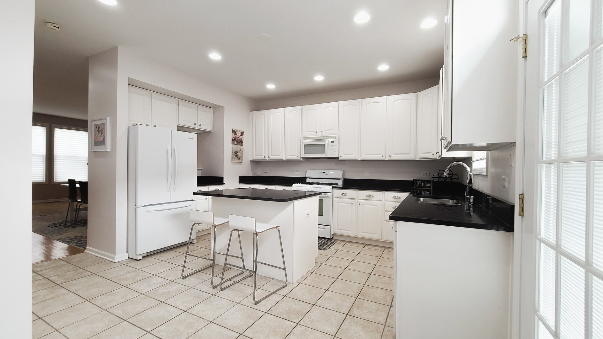 352 West Seminary Avenue, Unit 504 Wheaton, IL 60187 - Photo 10 of 24 a kitchen with a refrigerator a sink and cabinets