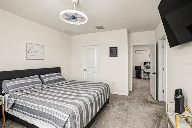 a bedroom with bed and a tv