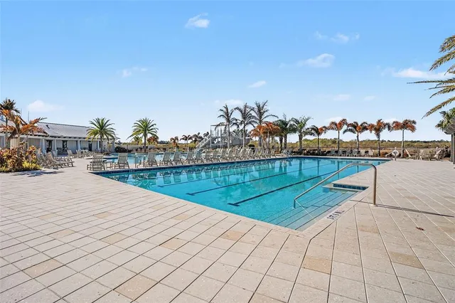 a view of swimming pool with a yard and seating area
