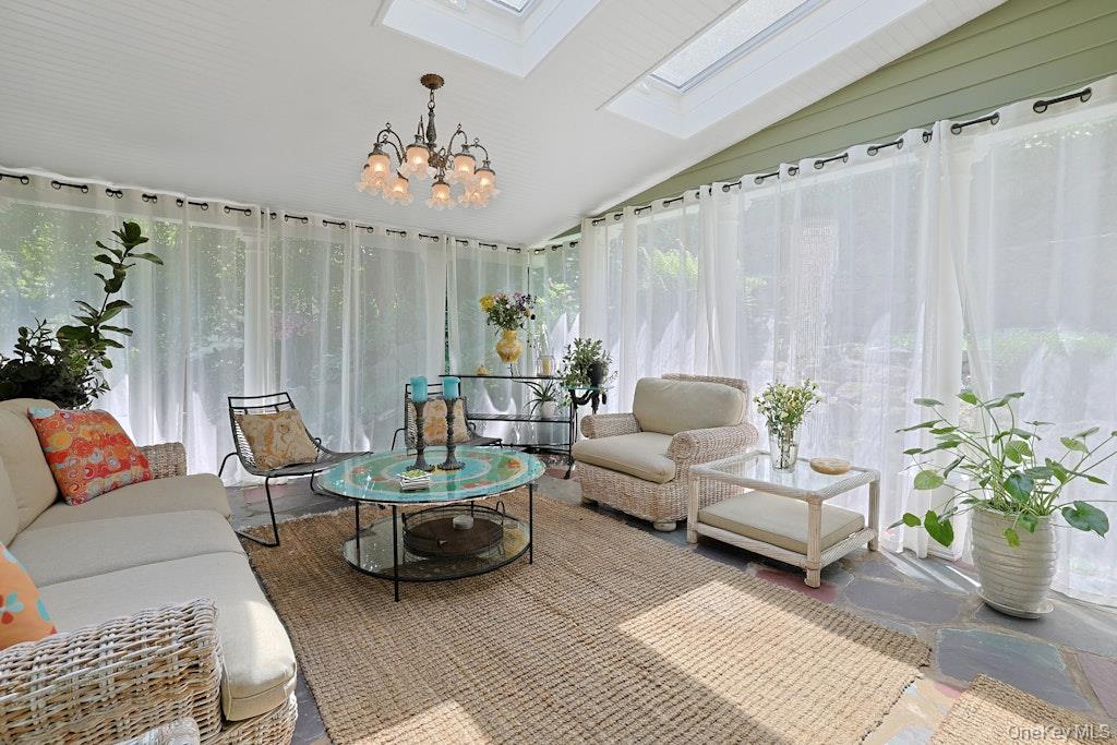 97 Underhill Road Scarsdale, NY 10583 - Photo 10 of 39 a living room with furniture and a chandelier