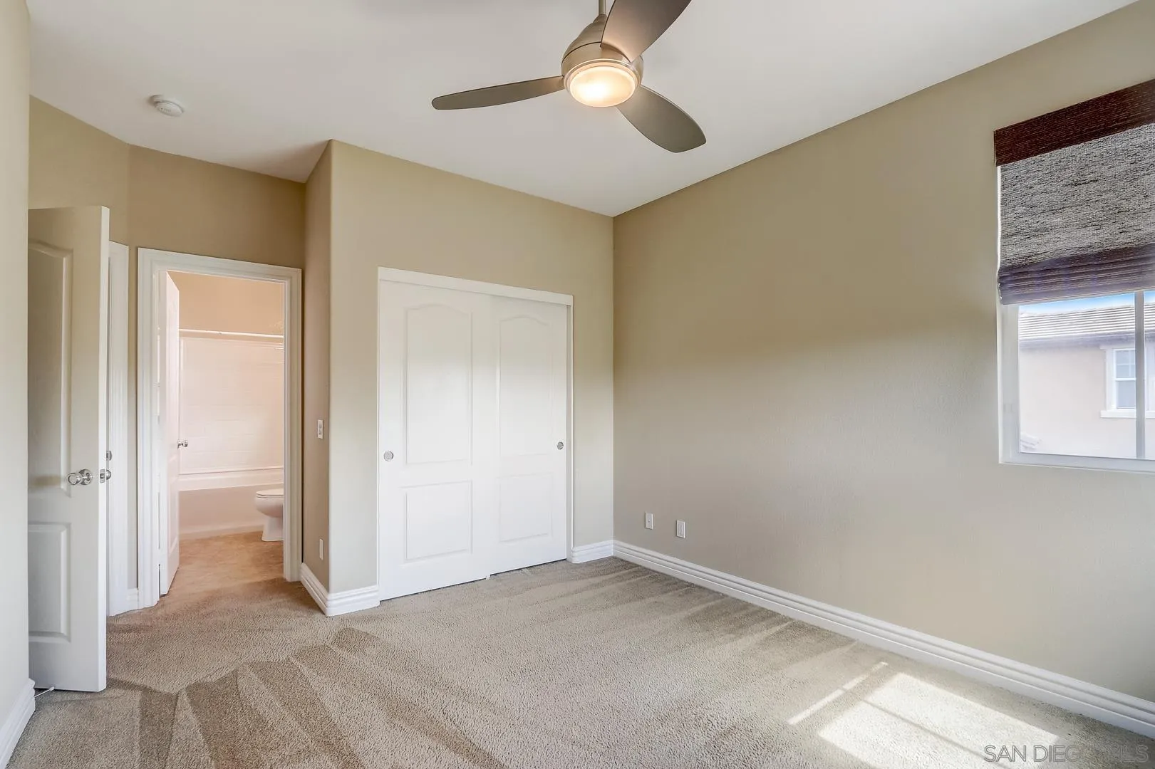 10185 Leavesly Trail Santee, CA 92071 - Photo 13 of 27 a view of an empty room with window and chandelier fan