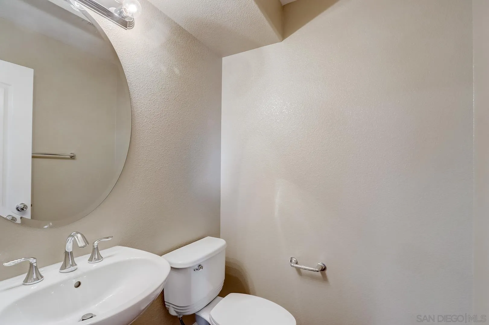 10185 Leavesly Trail Santee, CA 92071 - Photo 14 of 27 a bathroom with a sink mirror and toilet