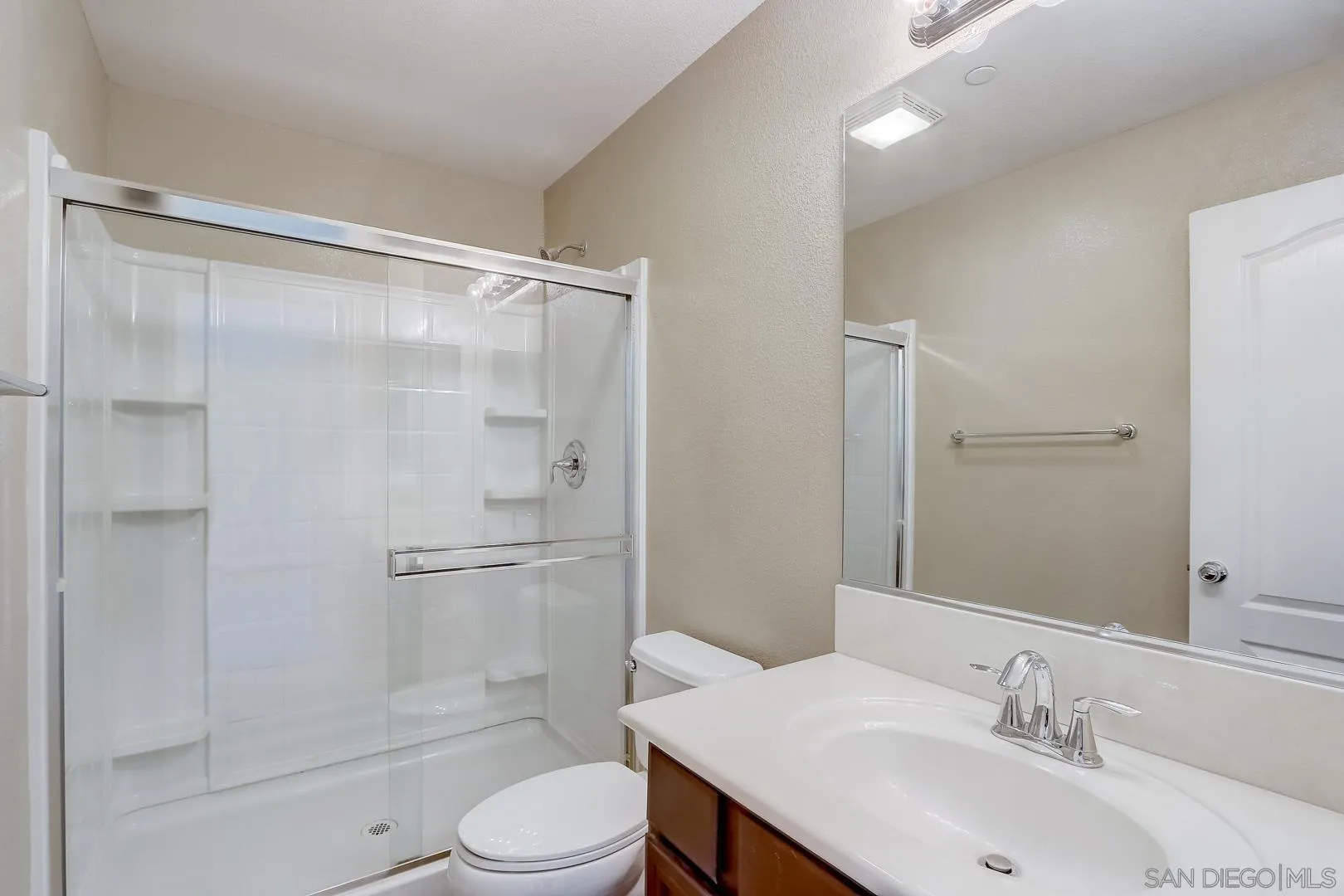 10185 Leavesly Trail Santee, CA 92071 - Photo 22 of 27 a bathroom with a sink toilet and shower
