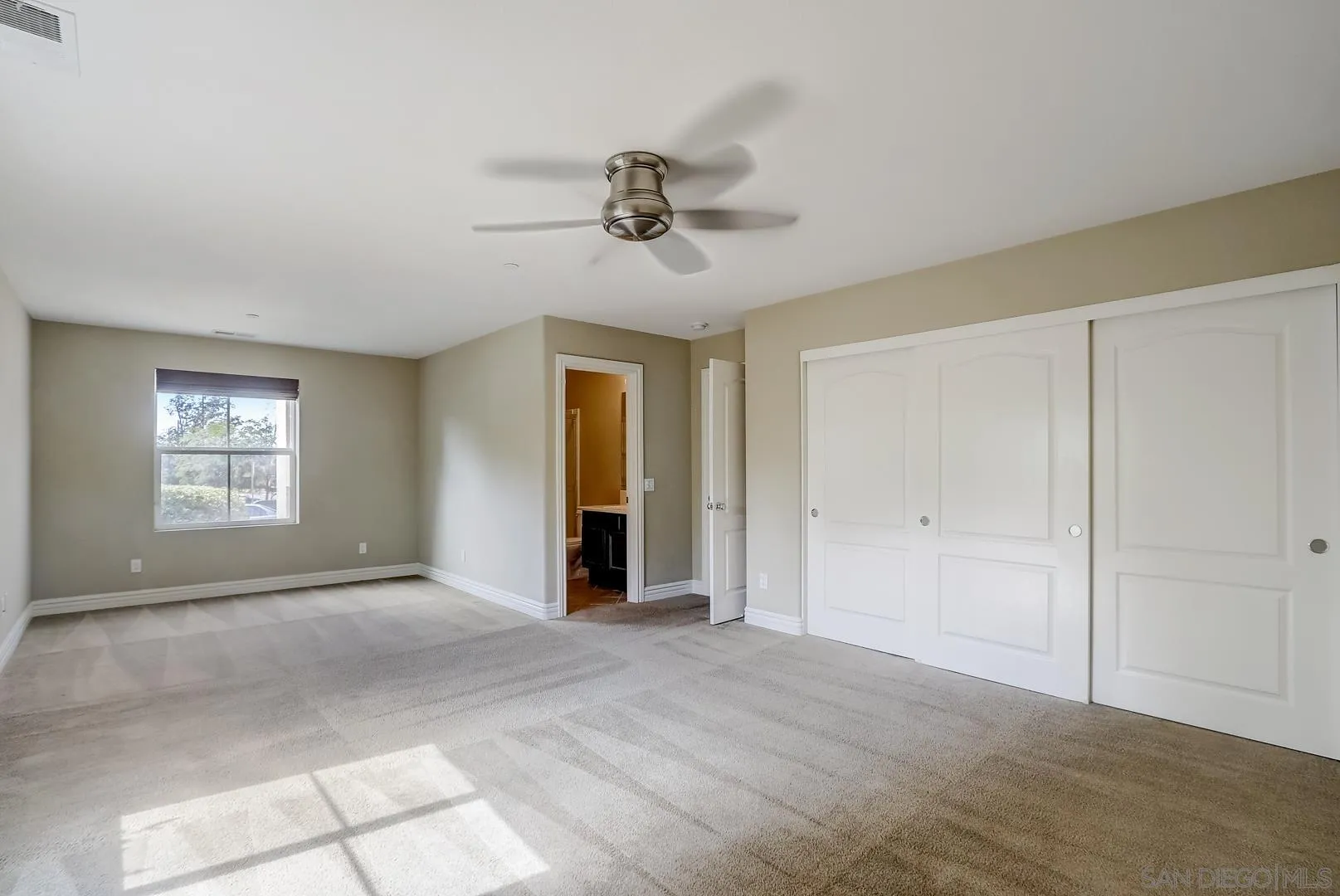 10185 Leavesly Trail Santee, CA 92071 - Photo 23 of 27 a view of a livingroom with a window and a ceiling fan