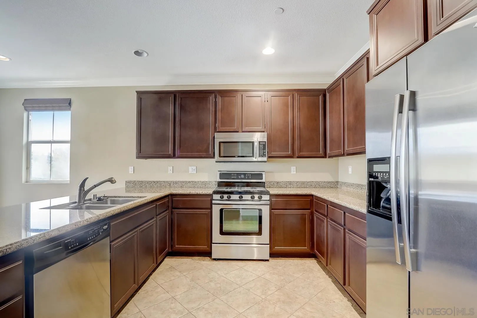 10185 Leavesly Trail Santee, CA 92071 - Photo 4 of 27 a kitchen with a sink stove and refrigerator