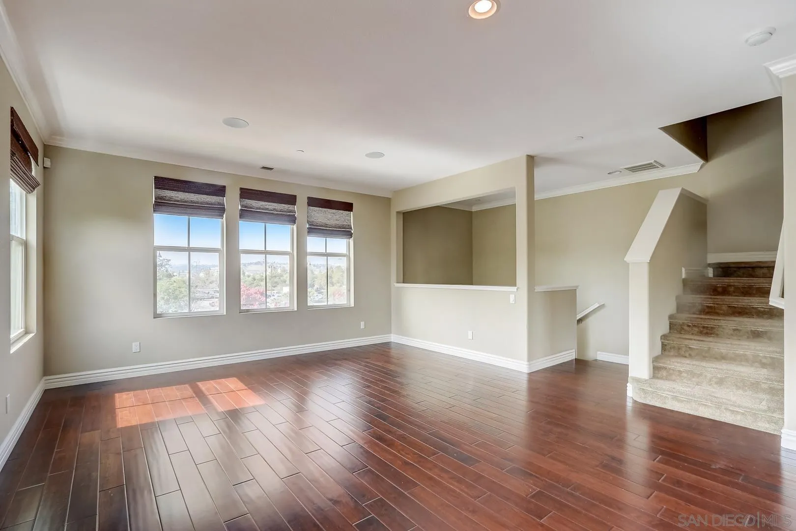 10185 Leavesly Trail Santee, CA 92071 - Photo 5 of 27 an empty room with wooden floor and windows