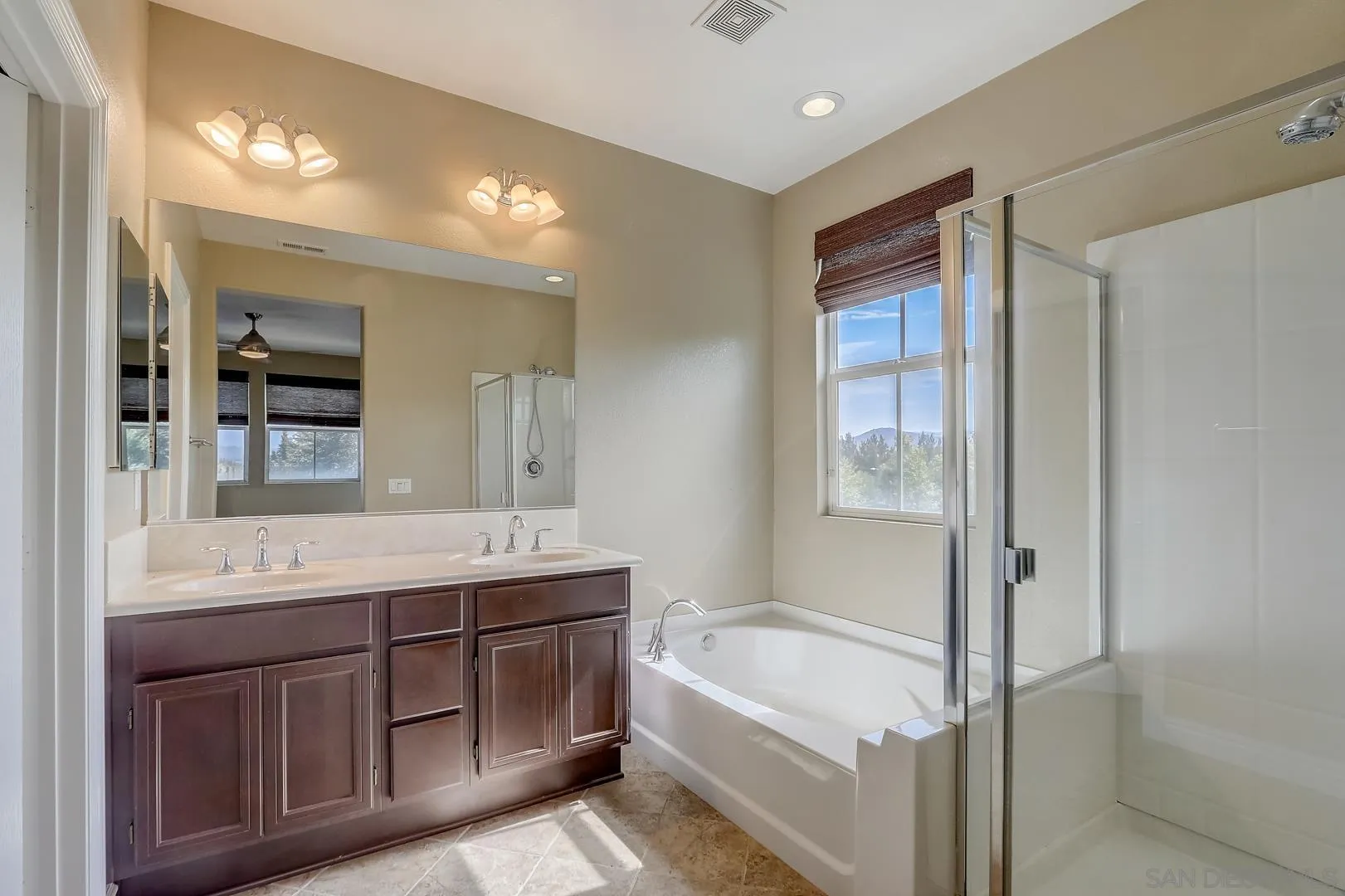 10185 Leavesly Trail Santee, CA 92071 - Photo 6 of 27 a bathroom with a tub a sink shower and mirror