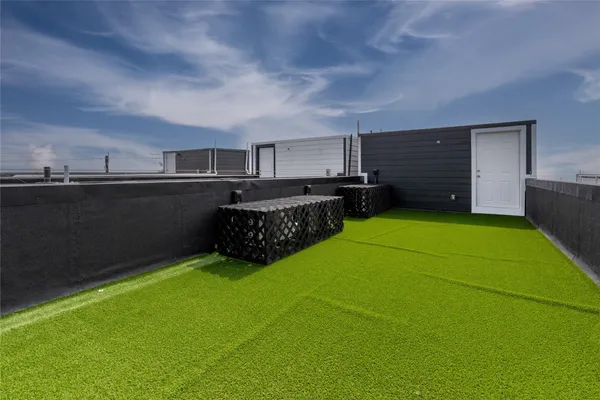 a view of a backyard with furniture and a garden