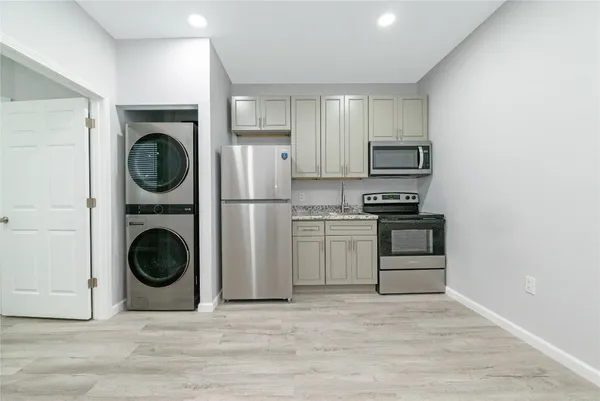 a utility room with sink dryer and washer