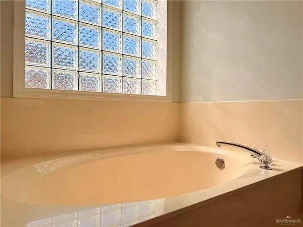 a bathroom with a bathtub and next to a window