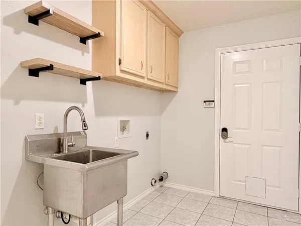 a close view of a sink a faucet and cabinets