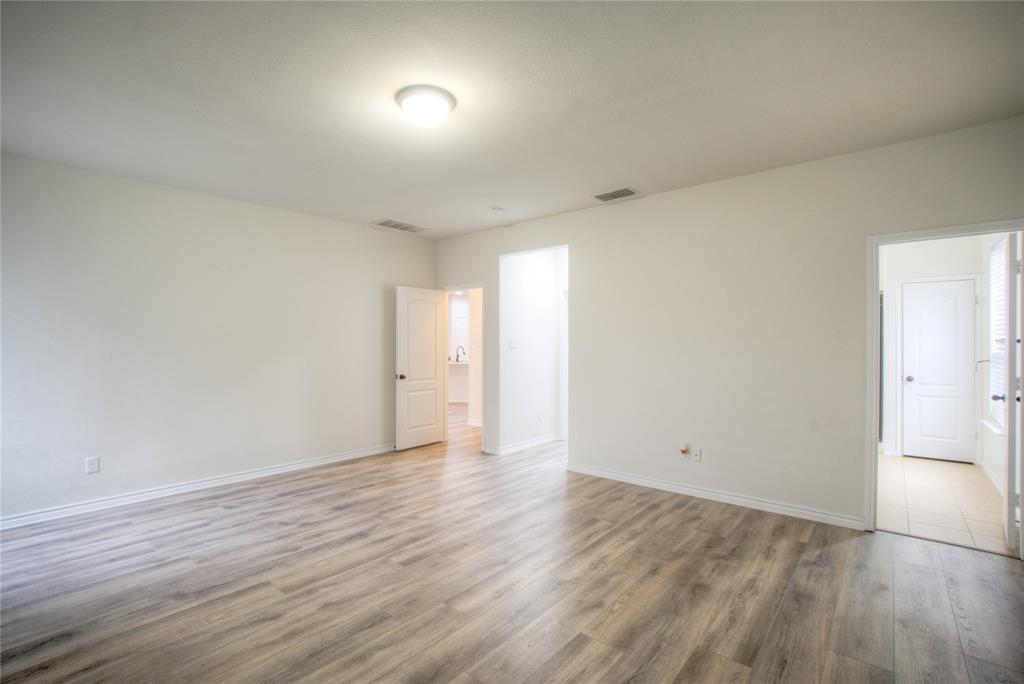 5633 Ridge Lake Drive Fort Worth, TX 76244 - Photo 11 of 23 Empty room featuring light wood finished floors and baseboards